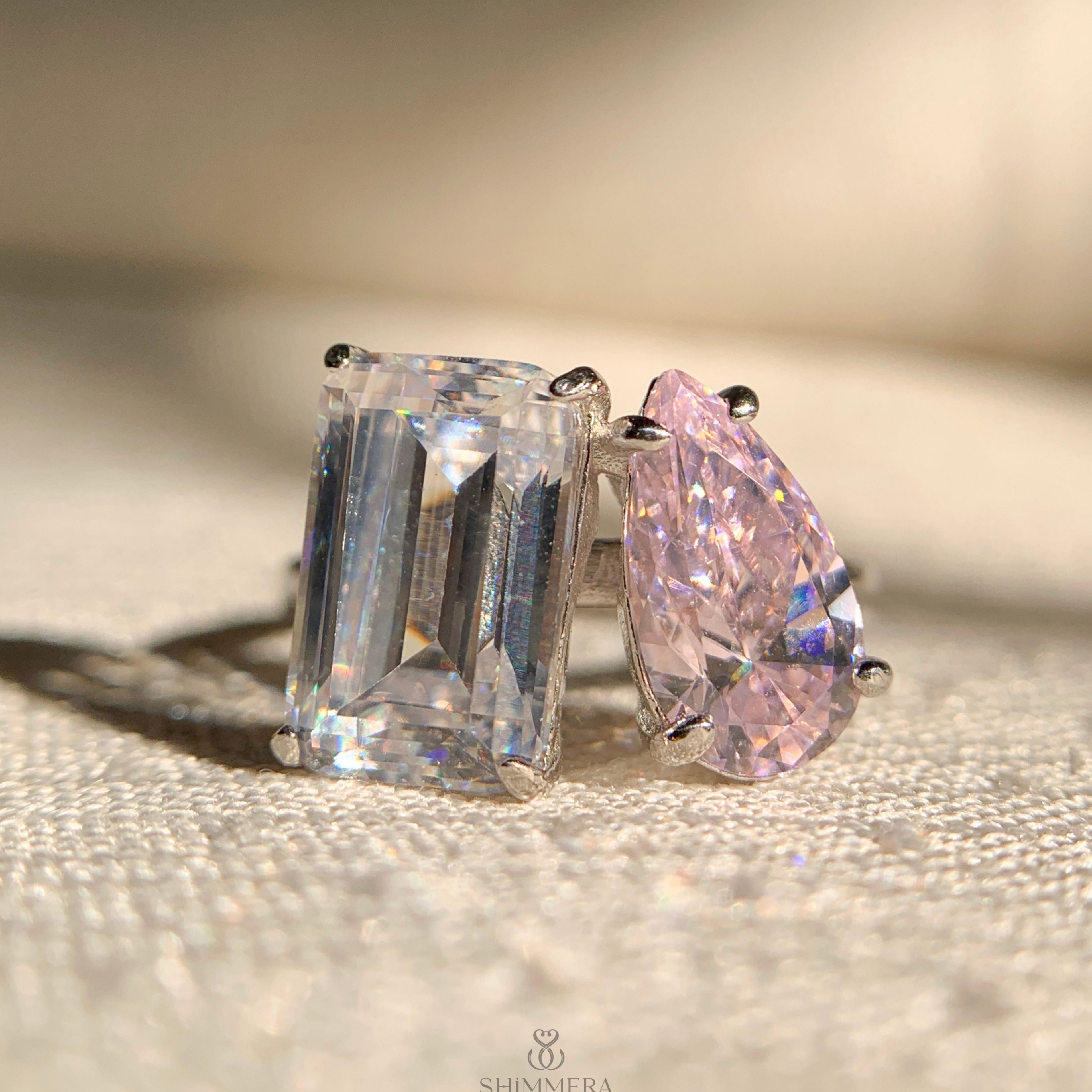 Emerald and pear double diamond engagement ring in white gold setting